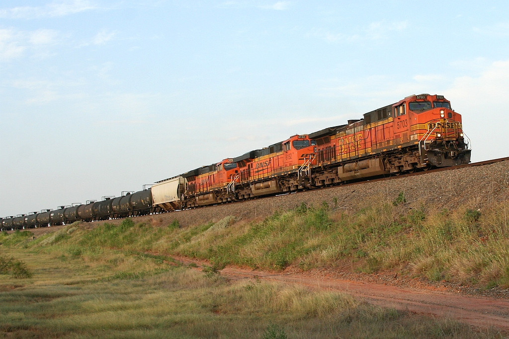 BNSF power pulling a freight up the hill